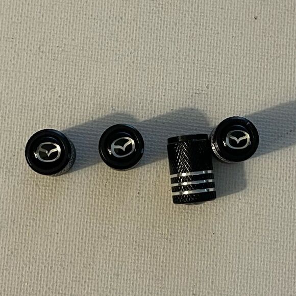 Mazda valve Stem caps in Black set of 4 NWT - Picture 1 of 4